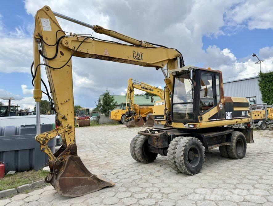 CAT M318 Gravemaskiner på hjul